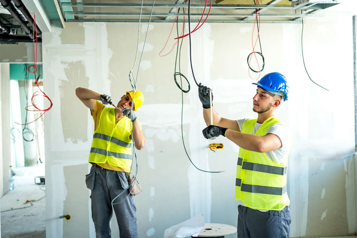 Construction workers dealing with wiring.