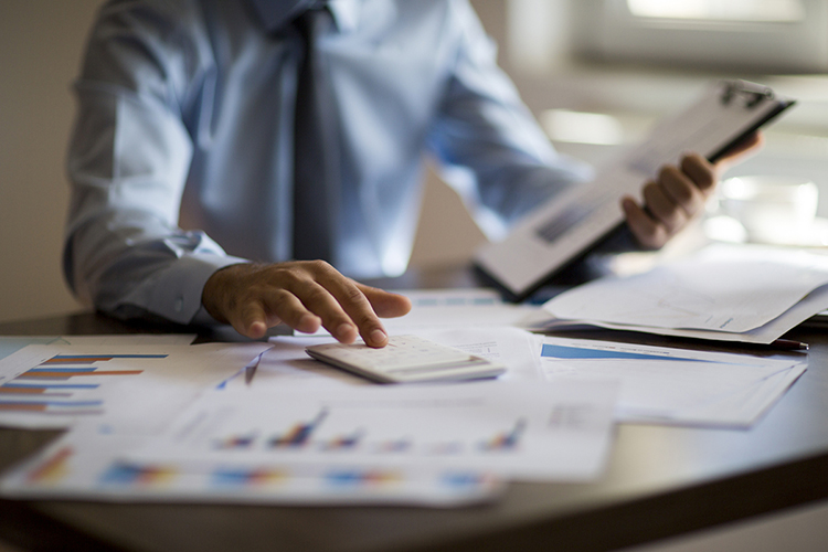 A business man studying budgets and tax filings